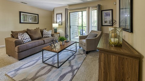 a living room with a couch and two chairs